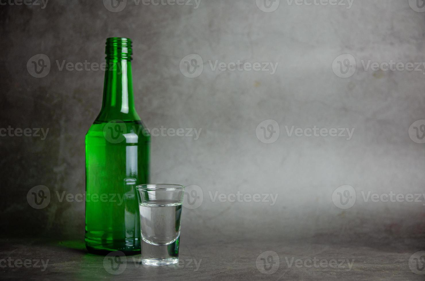 soju with glass on grey background, selective focus photo