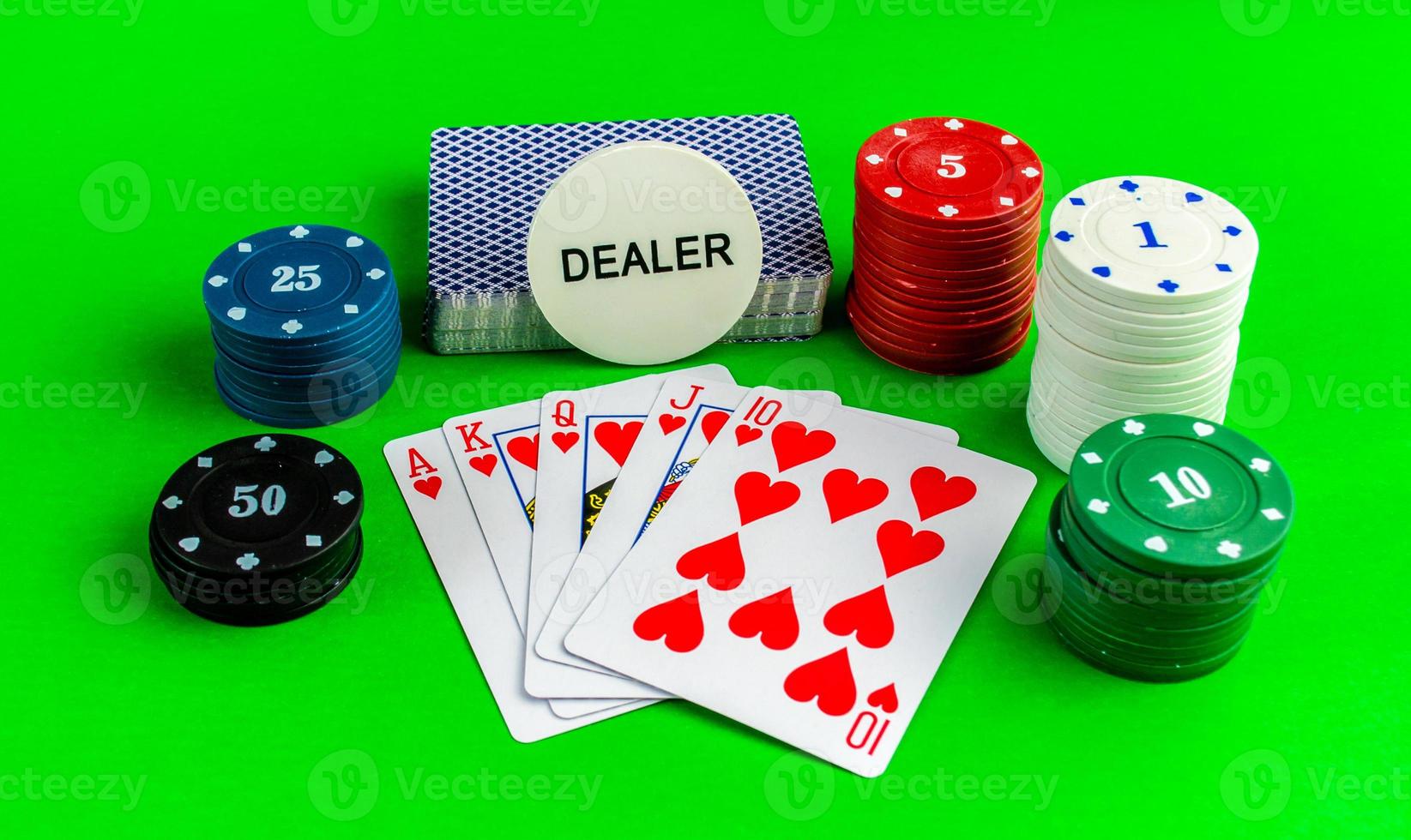 Poker, cards with a royal flush combination on a green table. photo