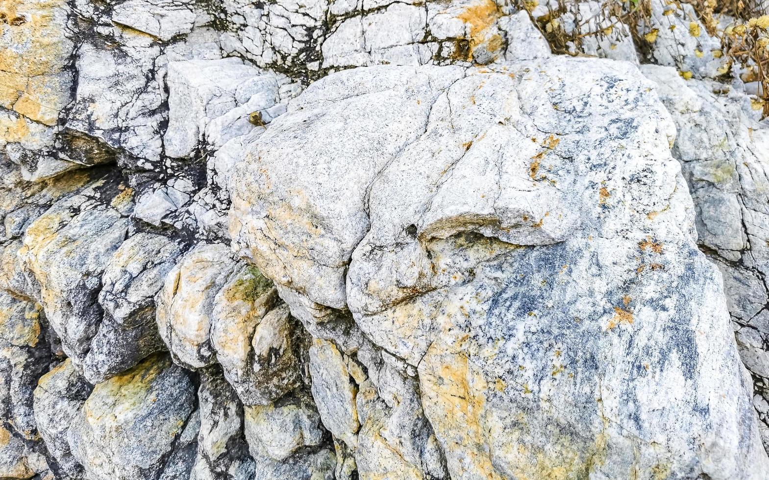 Beautiful rock cliff stone boulder texture pattern beach in Mexico. photo