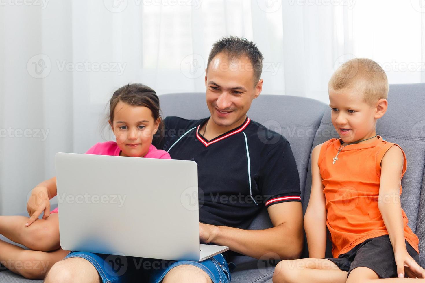 Father and children cartoon online at laptop, dad spending time together with kid playing game with daddy enjoying morning at home photo