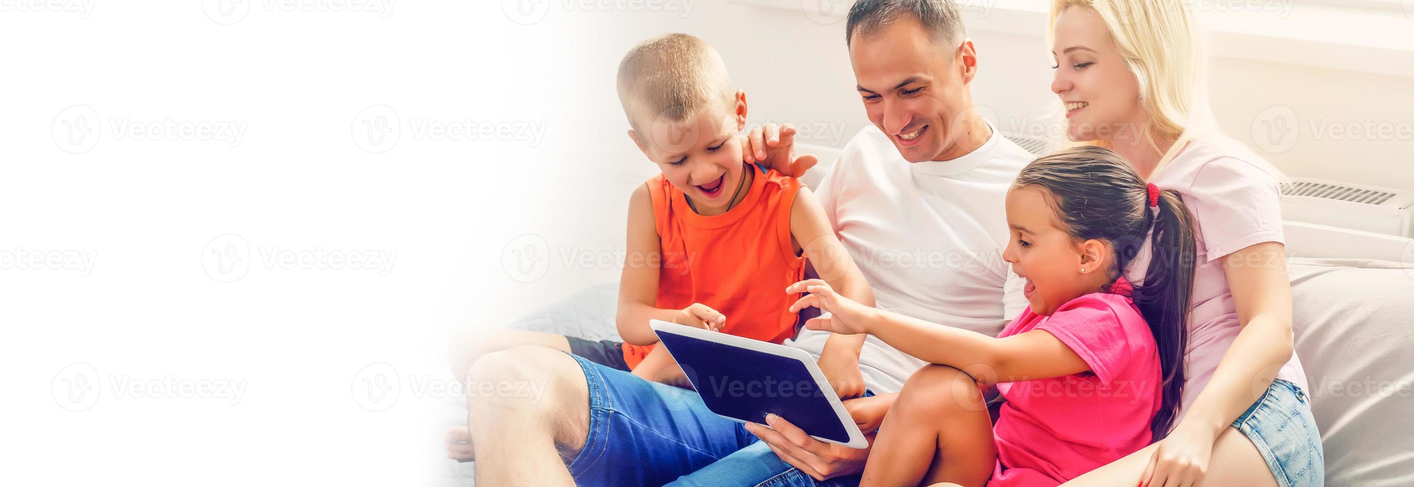 Family looking at laptop and laughing photo