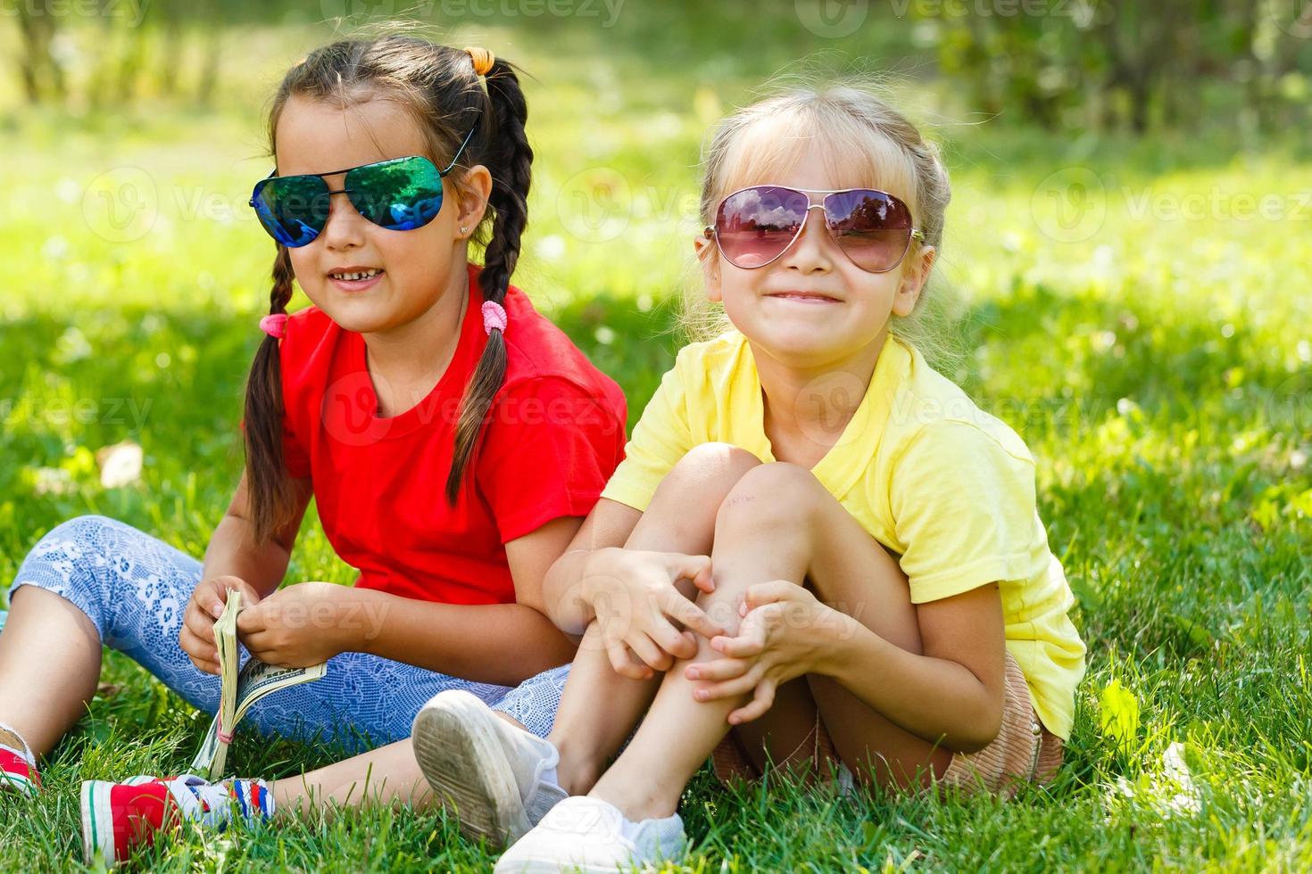 Close up of pre-teen friends in a park smiling to camera photo