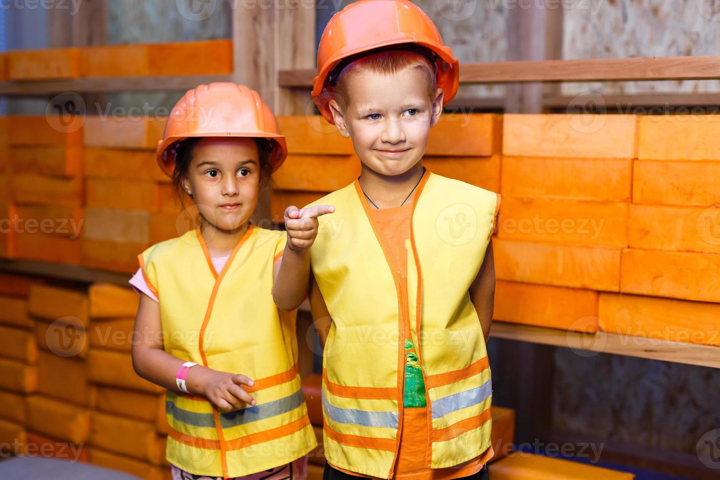 Cute little boy and girl playing with toy tools and smiling at camera photo