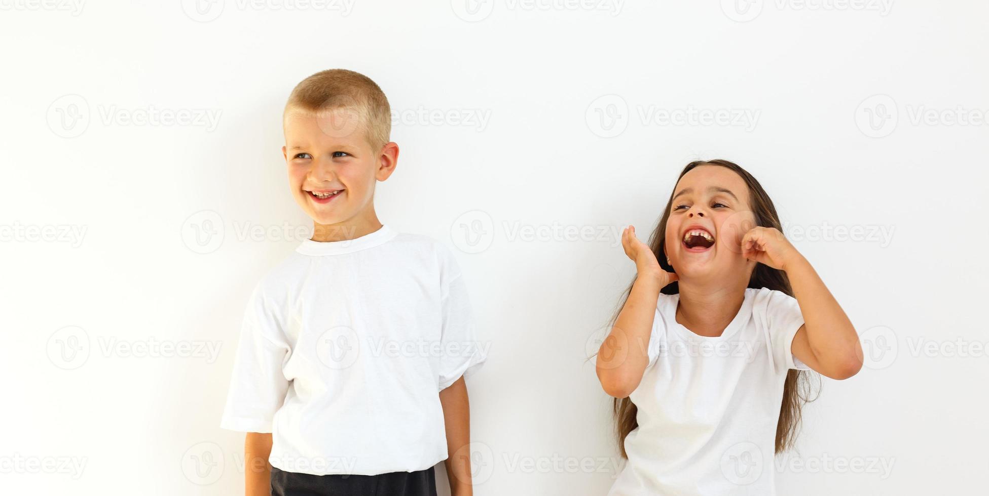 Little cute boy and girl hugging playing on white background, ha photo