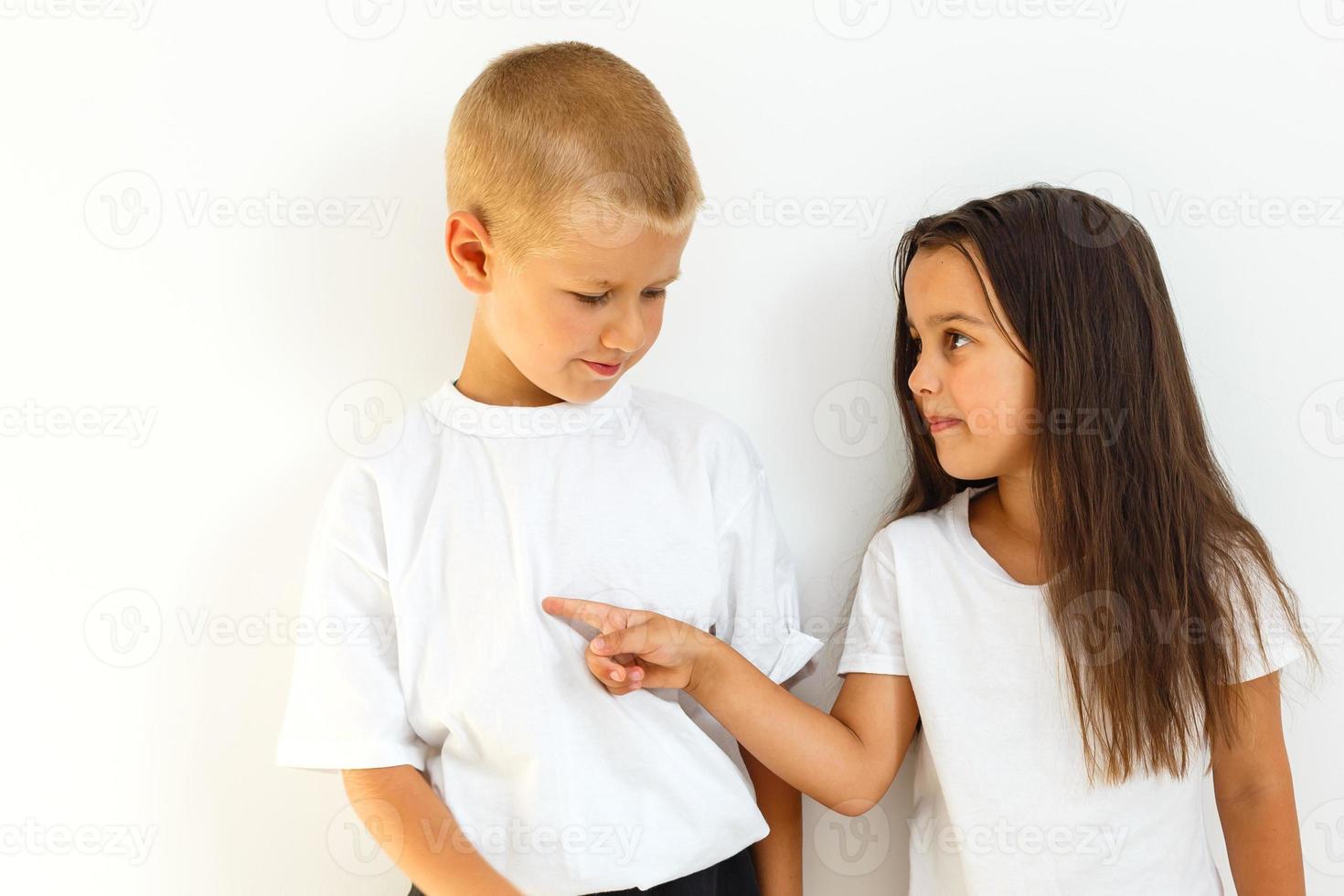 A portrait of a laughing girl and a smiling boy on the white background photo