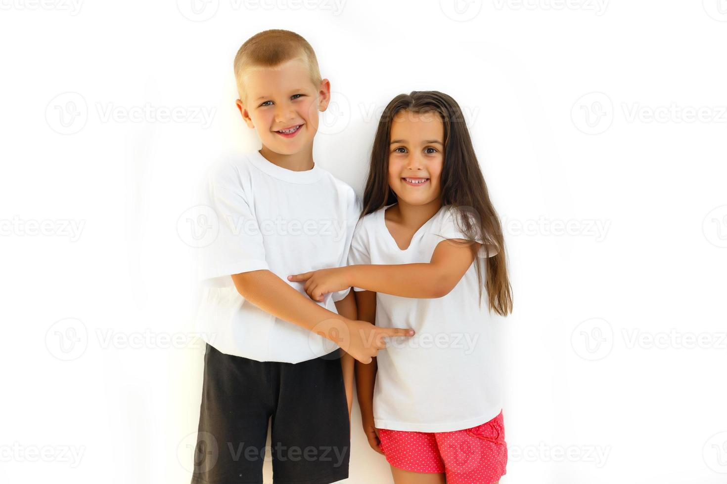 Teens brother and sister. The concept of a happy childhood, beauty, people, fashion, healthy lifestyle. Isolated on white background. photo