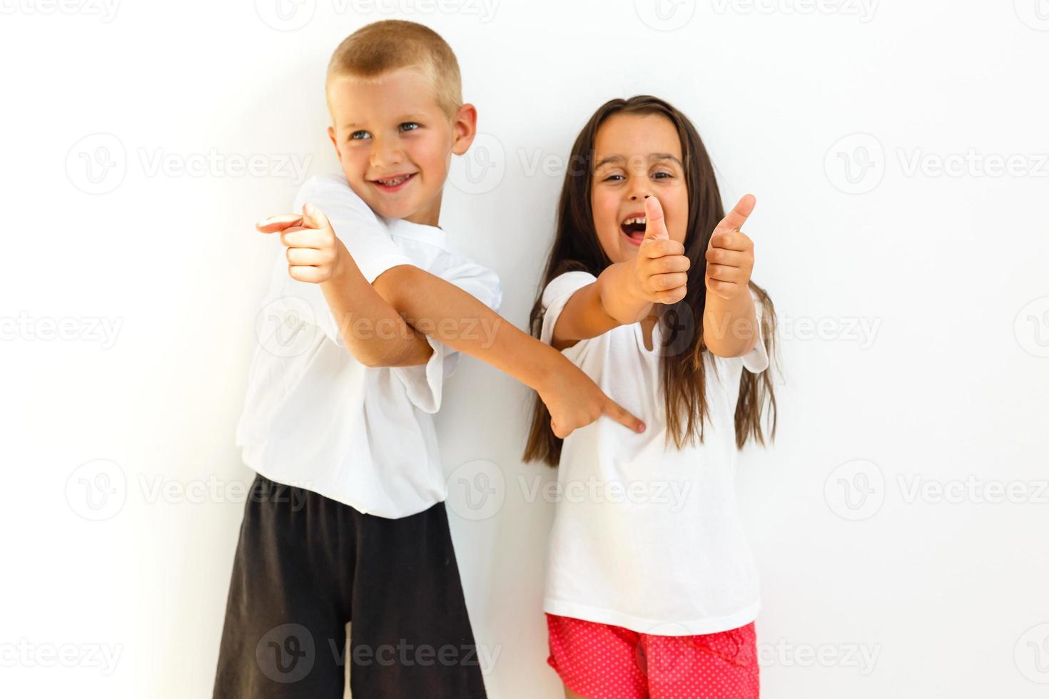 A portrait of a laughing girl and a smiling boy on the white background photo