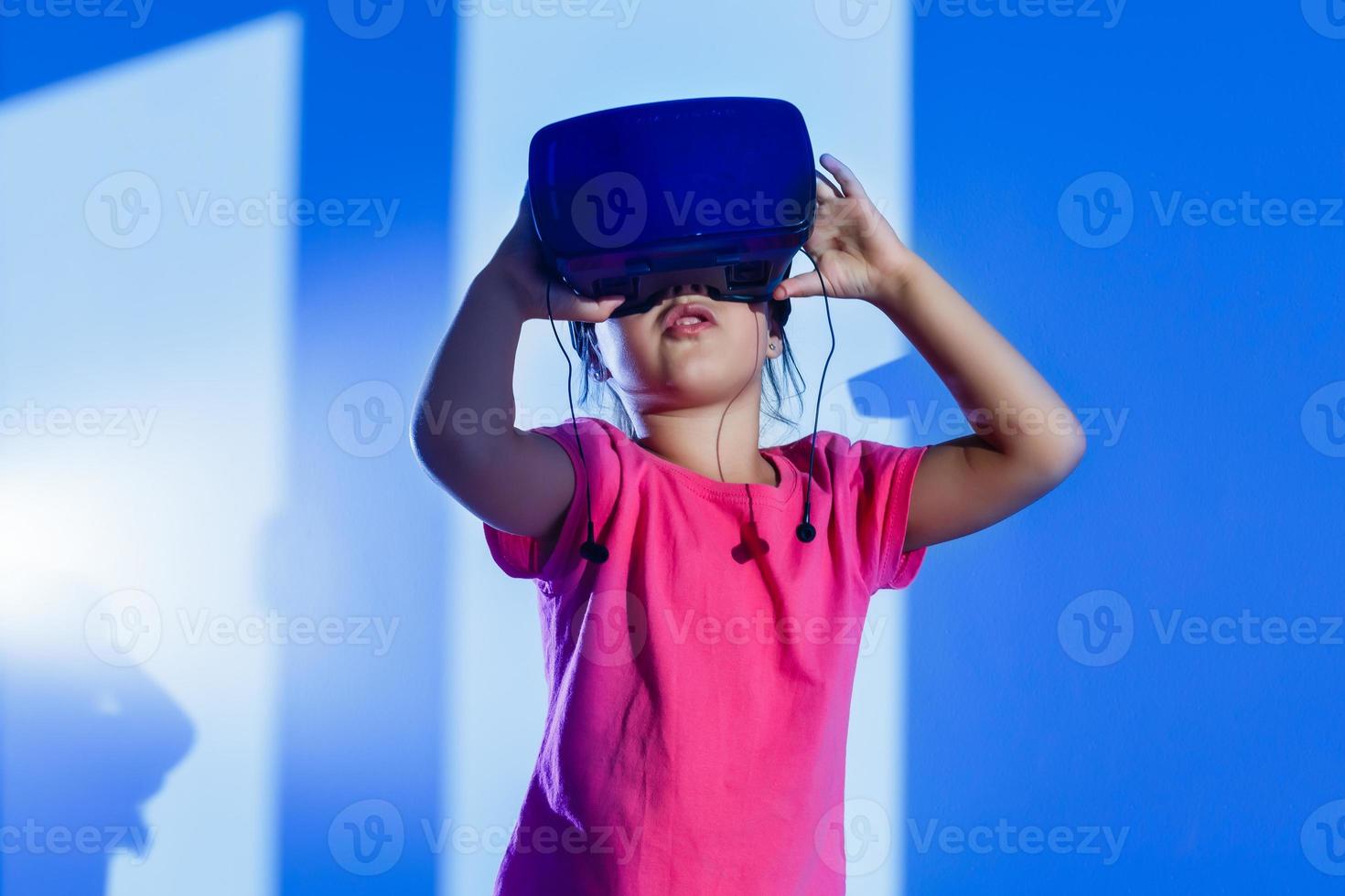 Virtual experiment. Smart cute happy girl touching VR glasses which she wearing when smiling photo