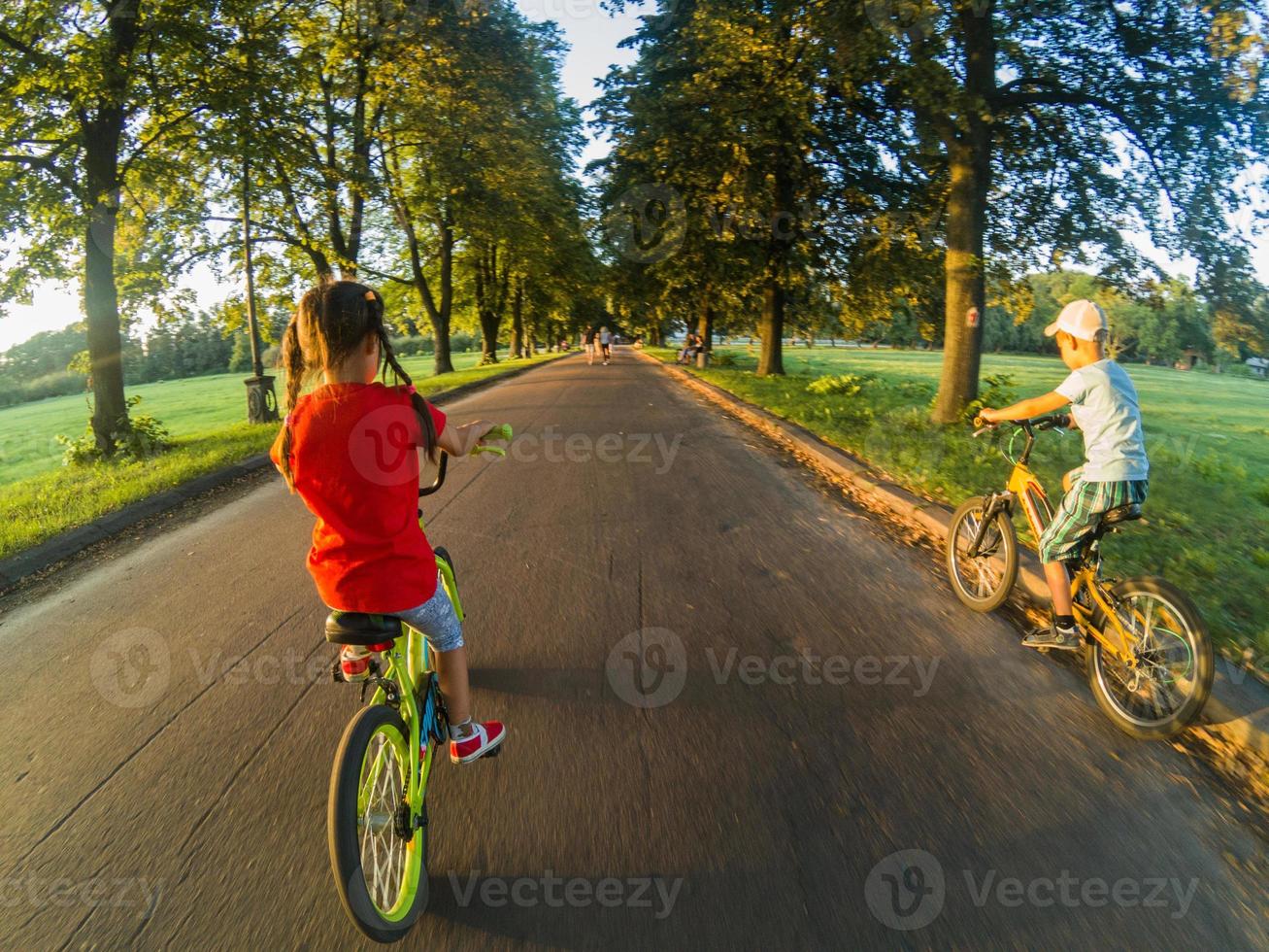 children on bicycles in the park near school. photo