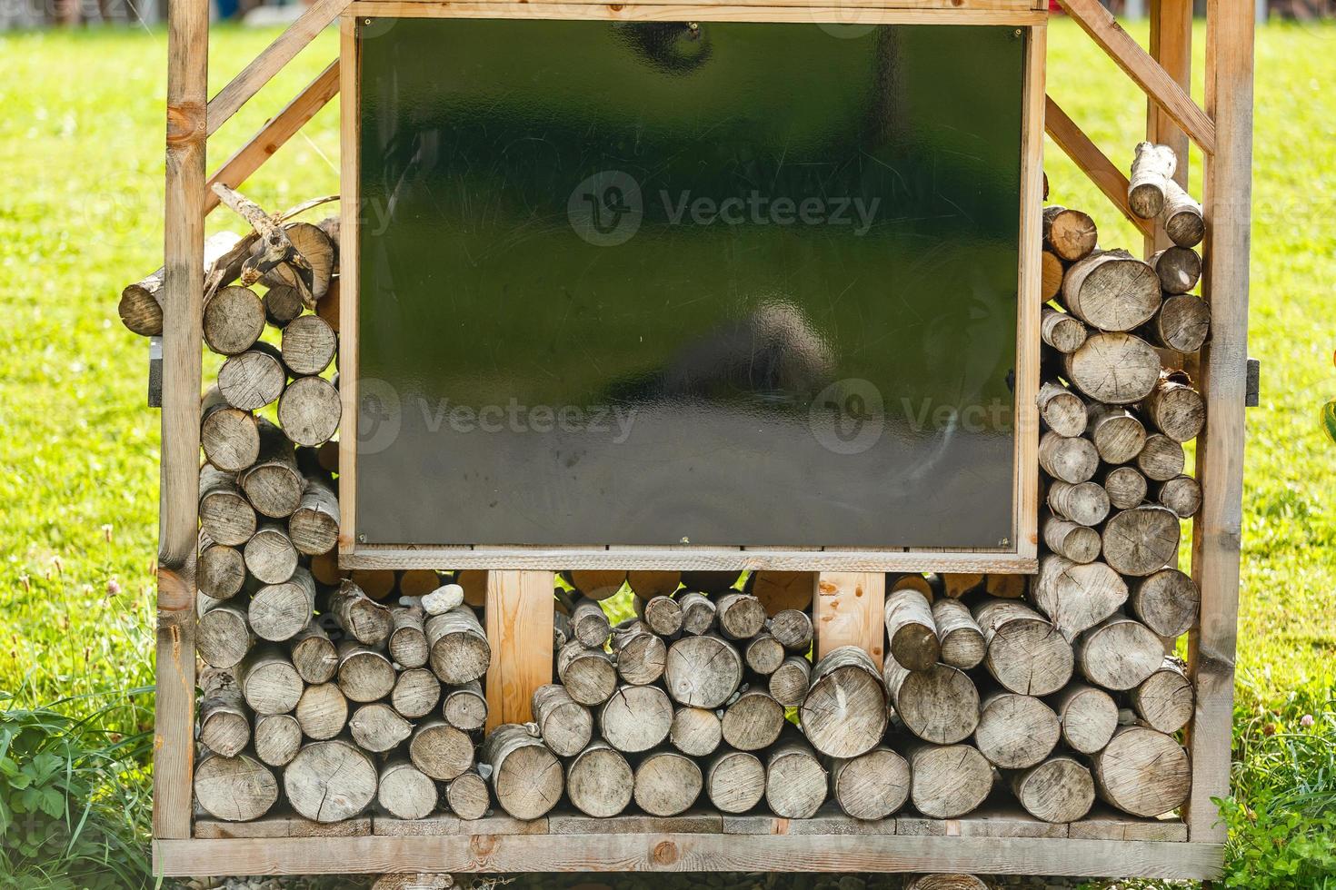 Firebox in the garden. A lot of firewood is stacked in a high firebox. Energy Saving Technologies photo