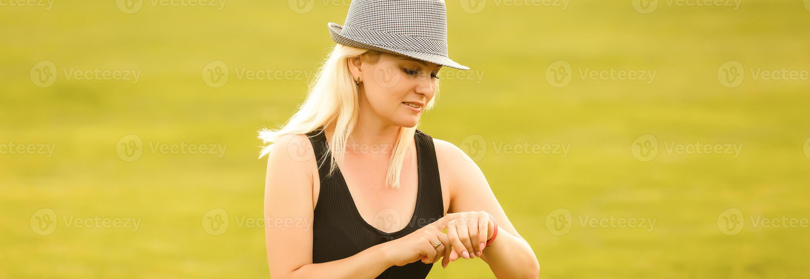 Yoga woman on green grass girl relaxing in a field. Yoga woman on green park girl doing gymnastics outdoors. Meditating woman in meditation in yoga pose practicing outdoors. photo