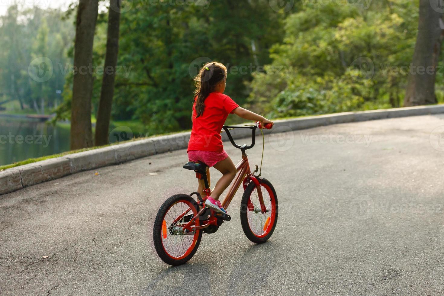 Girl on a bicycle spring morning photo