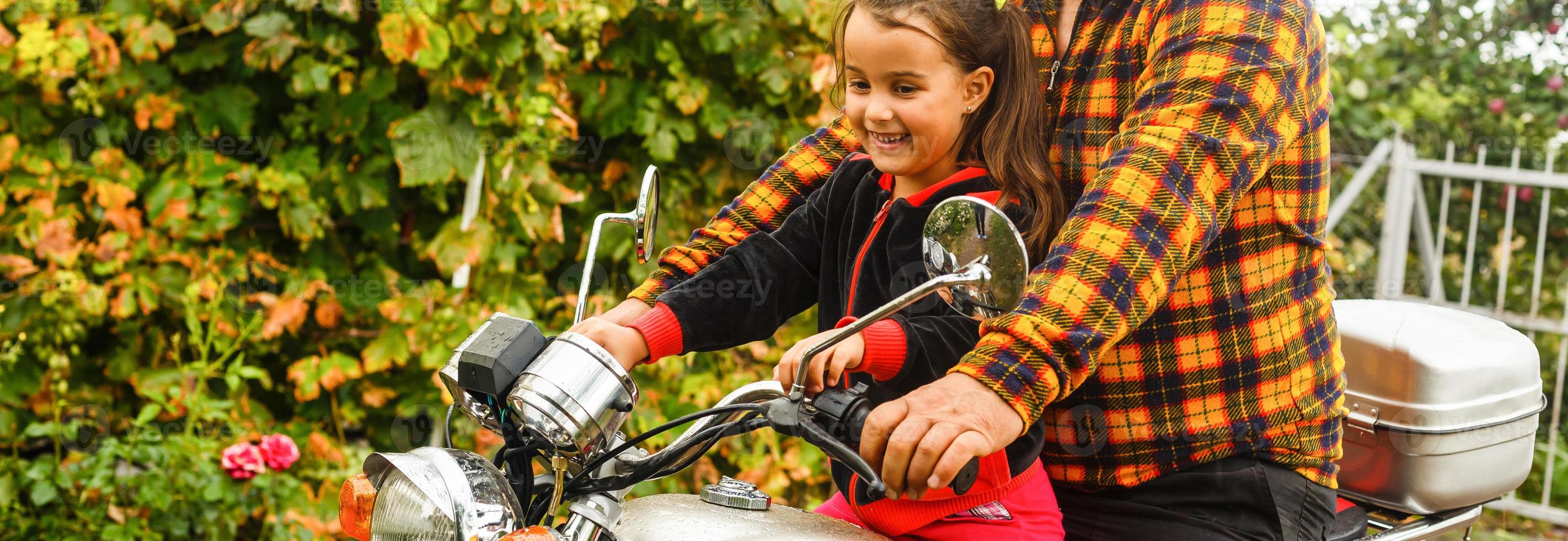 Happy grandfather and his granddaughter in handmade sidecar bike smiling motorcycle photo