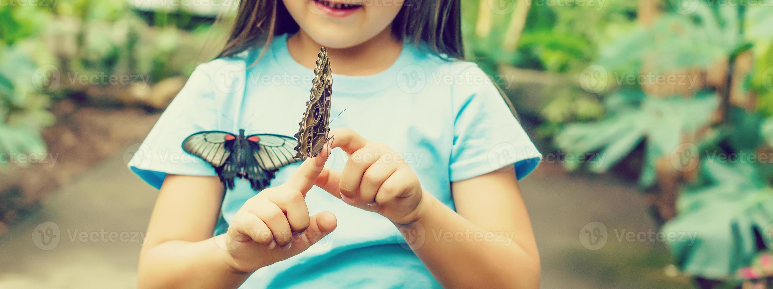 Beautiful butterfly sitting on the girl hand photo