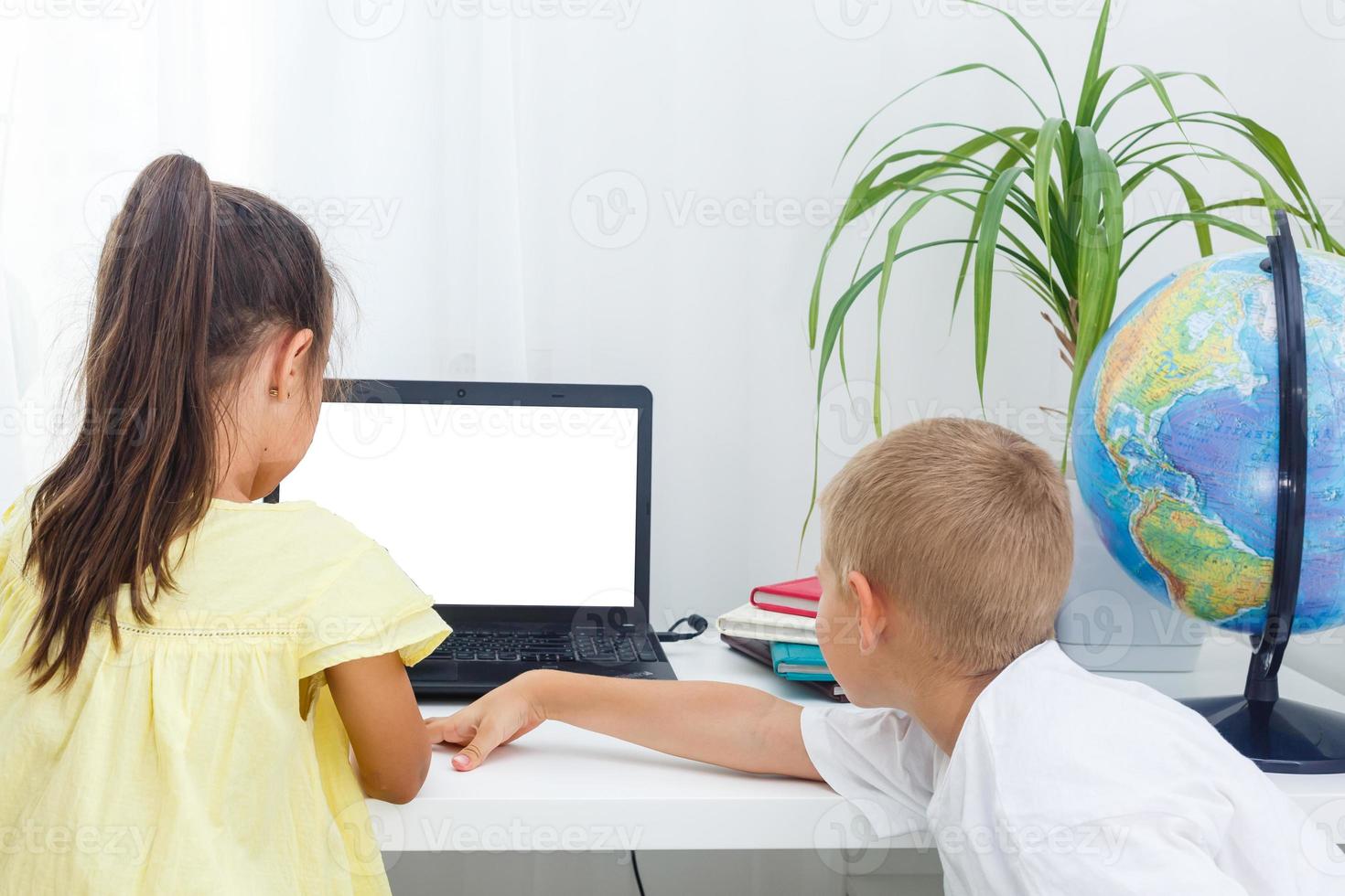 Two students working at laptop photo