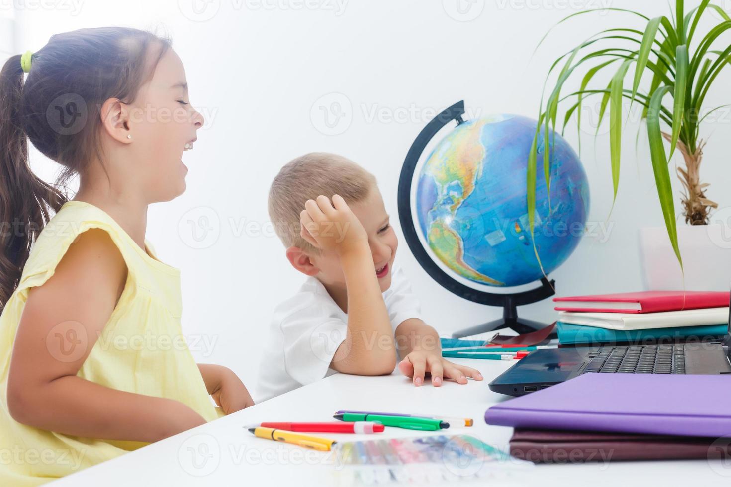 Happy children smiling and laughing in the classroom photo
