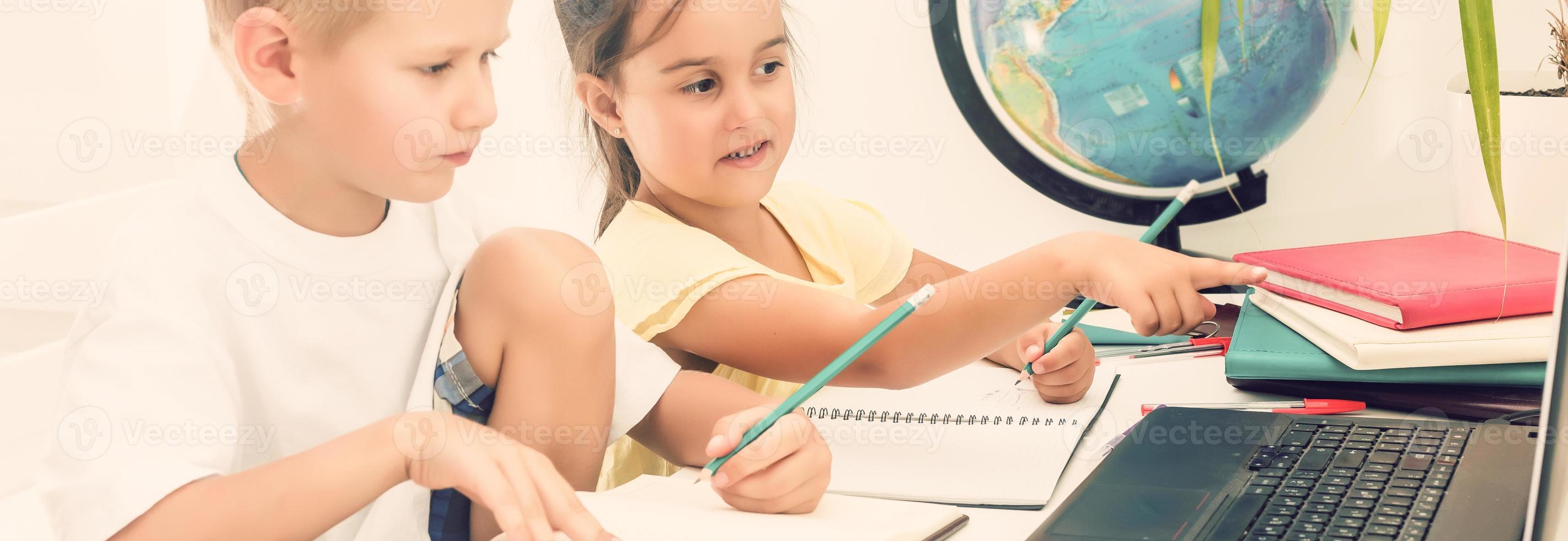 Boy and girl using a laptop at school. photo