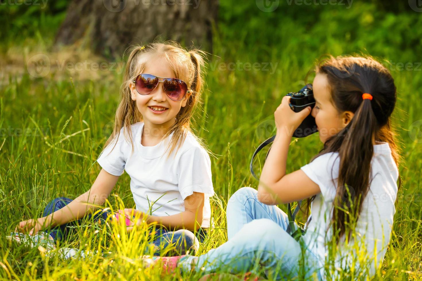 Best friends swinging in a park photo