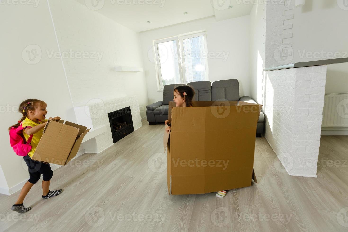 funny kids boy and girl running inside luxury big modern house on moving day, cute children entering exploring new home photo