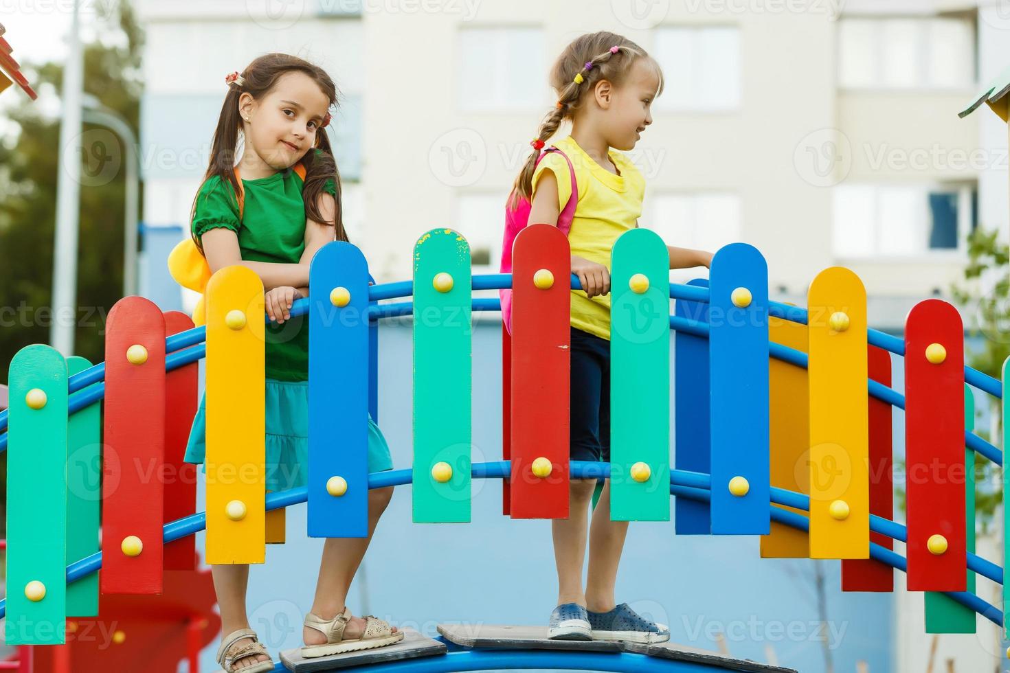 Two girls on the red slide photo