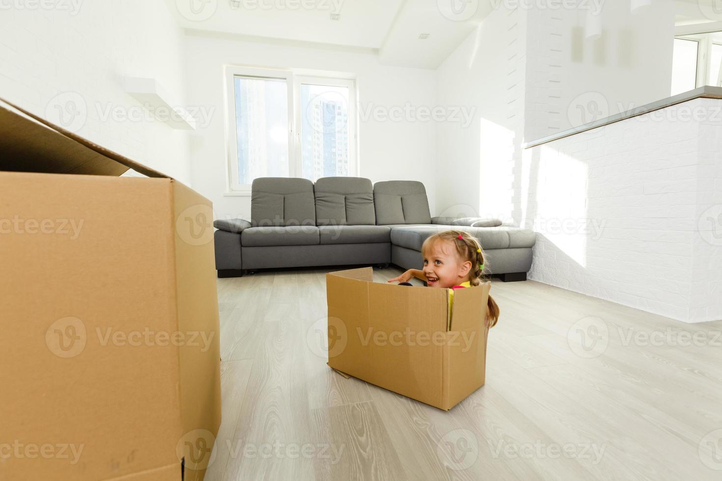 Little girl inside a paper box photo