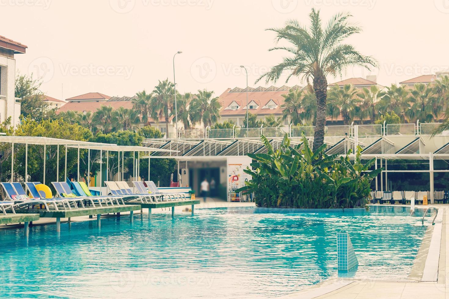Resort swimming pool with empty plank board photo