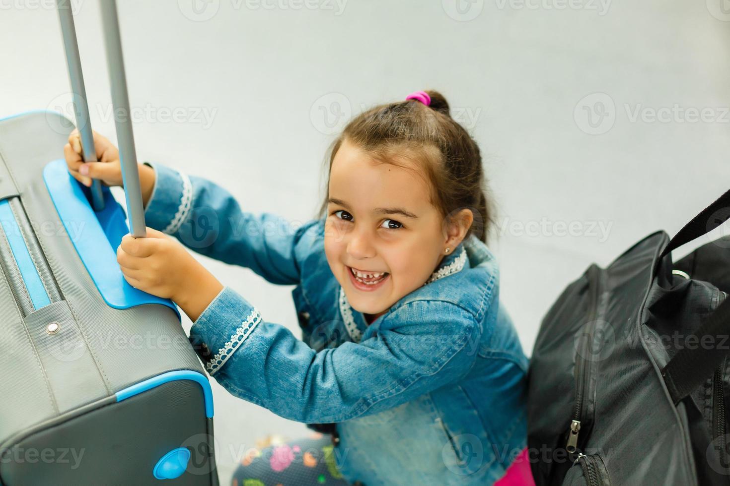 Little girl with suitcase travel in the airport, kids travel photo