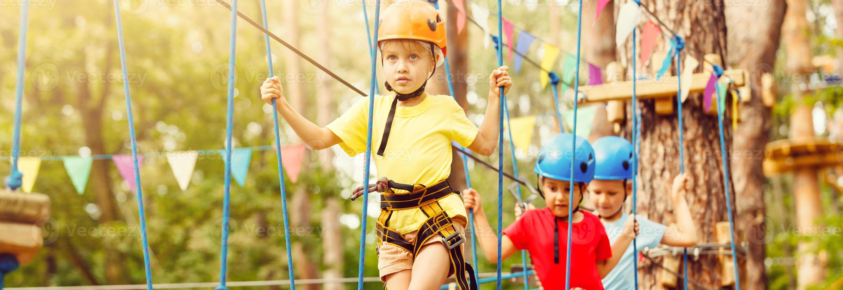 Active children's recreation. Climbing the rope park photo