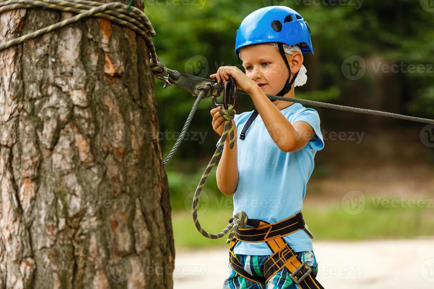 Active children's recreation. Climbing the rope park photo