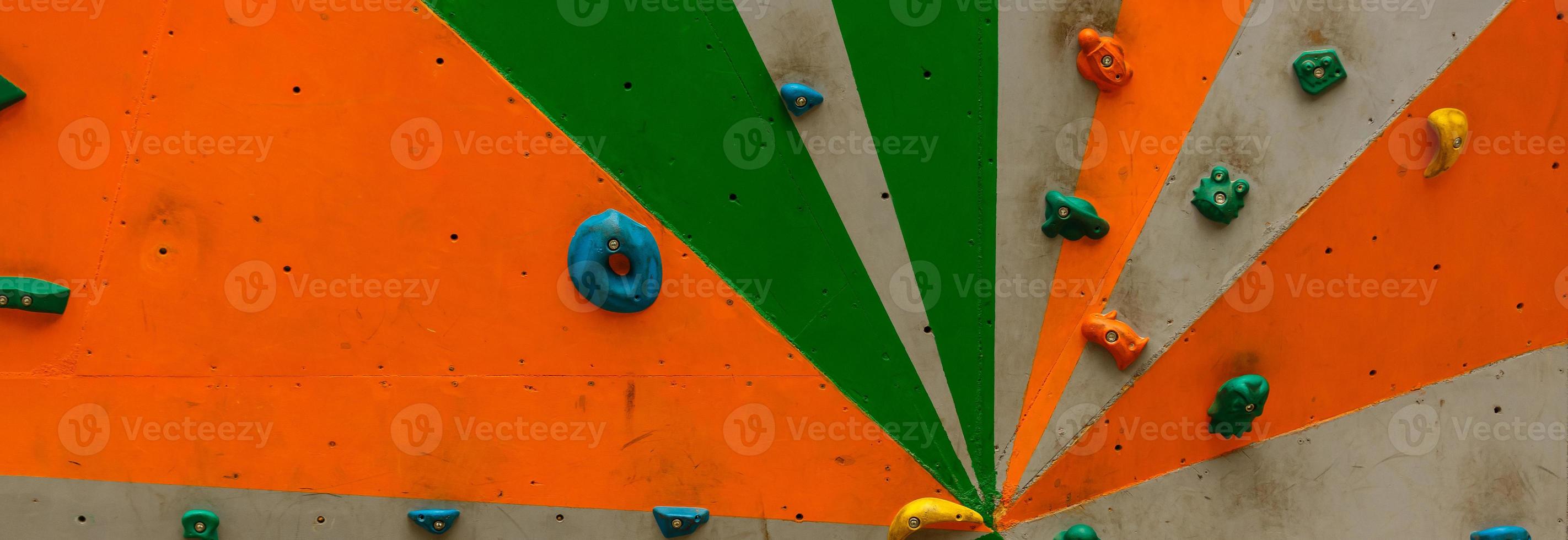wall with climbing holds in gym photo