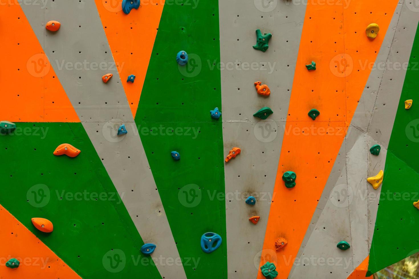 wall with climbing holds in gym photo