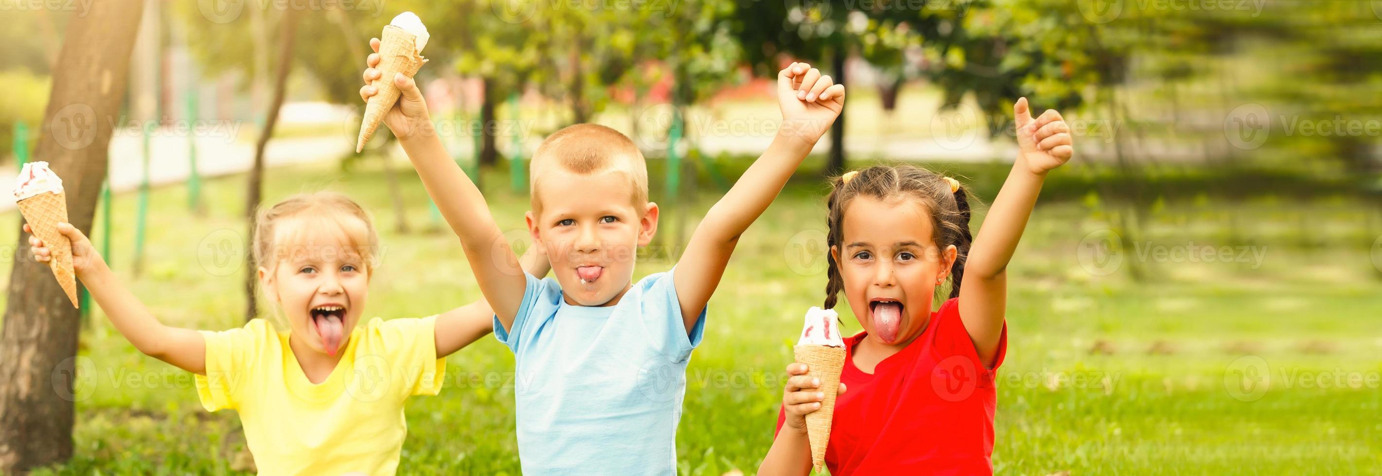 Group of happy little friends having fun at the yard. photo