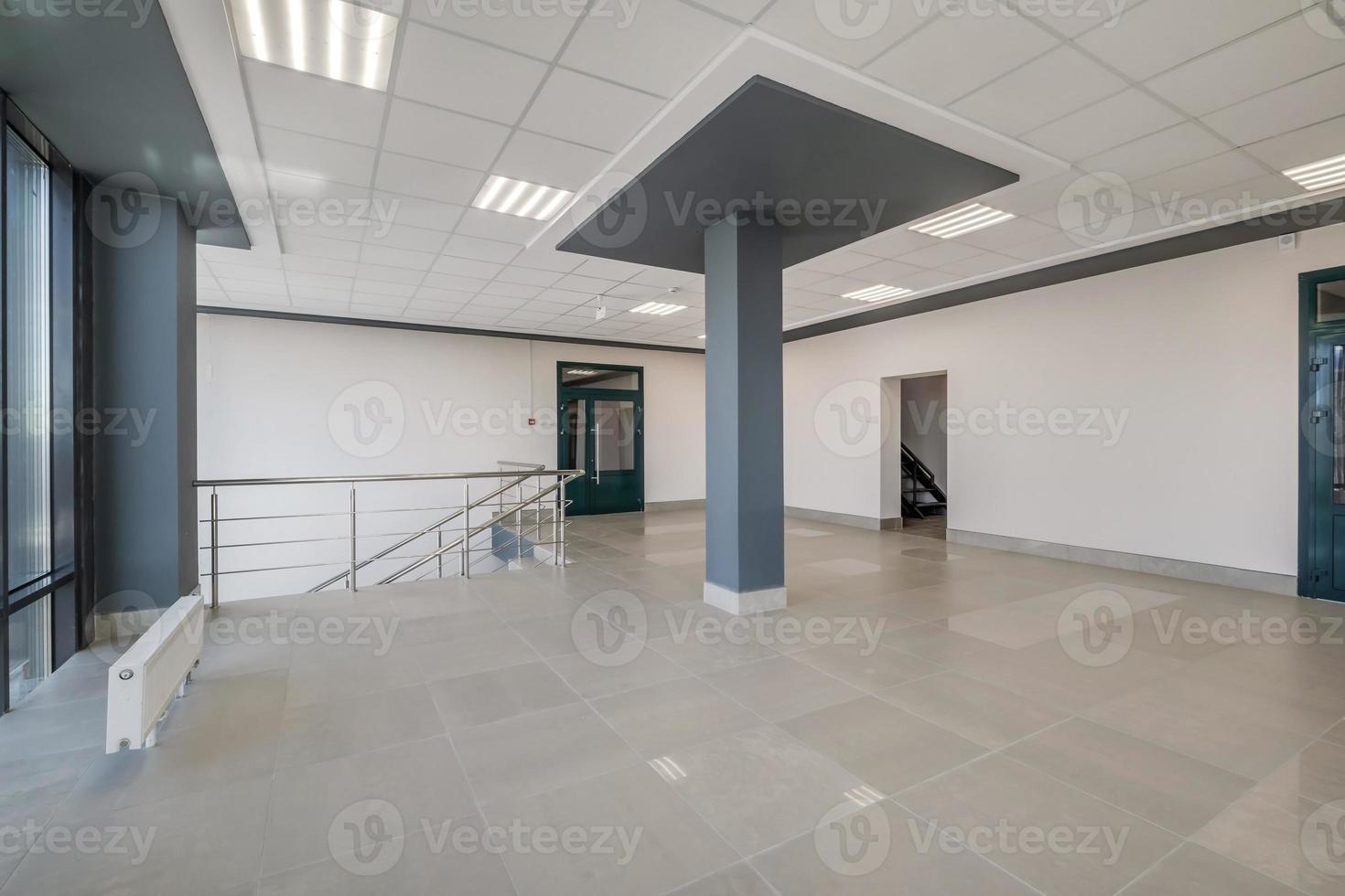 panorama view in empty modern hall with columns, doors and panoramic windows photo