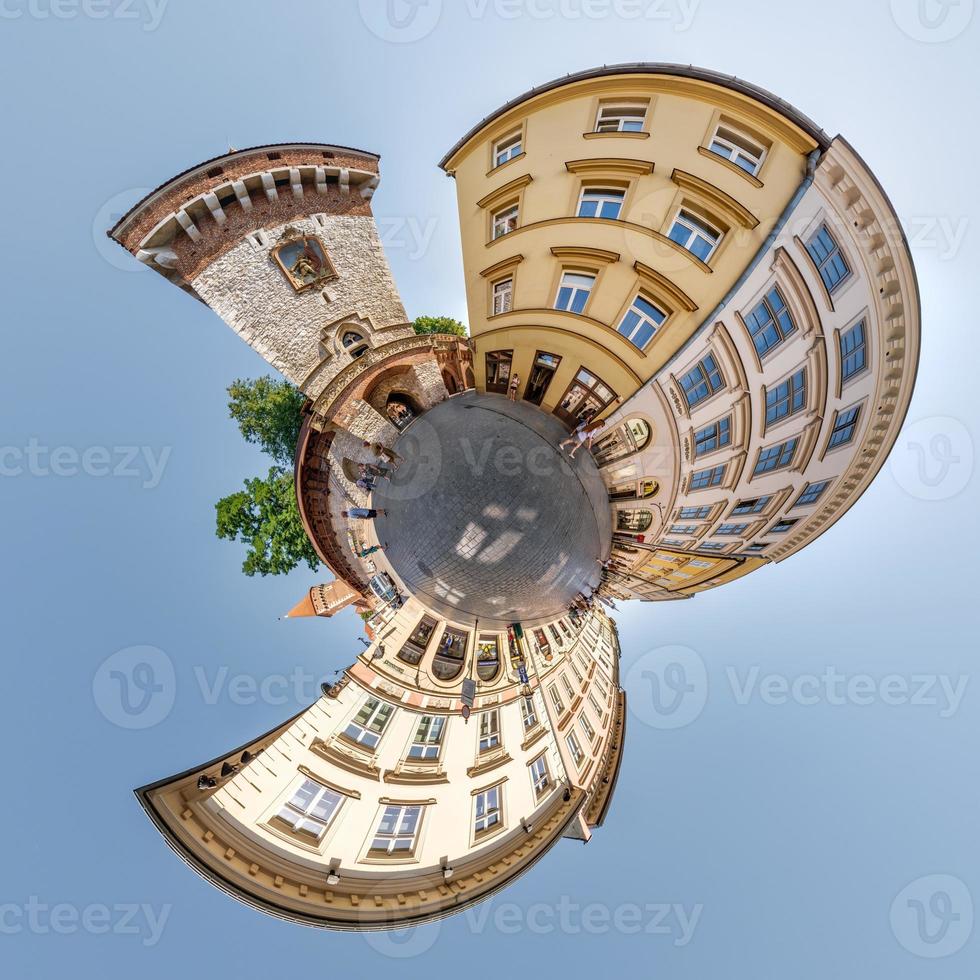 Little planet and spherical aerial 360 panorama view on street ancient medieval city with church and historic buildings photo