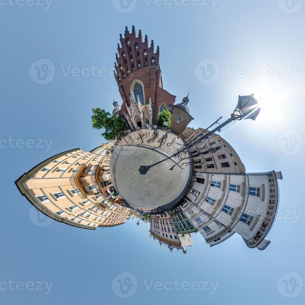 Little planet and spherical aerial 360 panorama view on street ancient medieval city with church and historic buildings photo