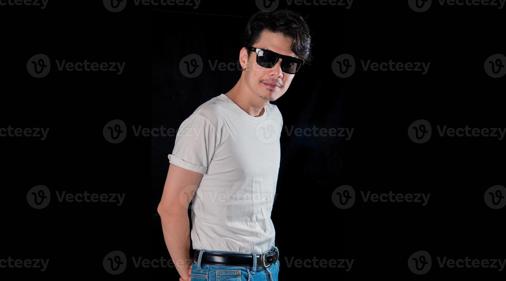 Portrait of men with sunglasses standing looking camera  on dark studio background , asian photo