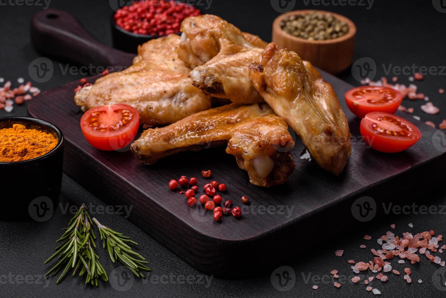 Baked chicken wings with salt, spices and herbs photo