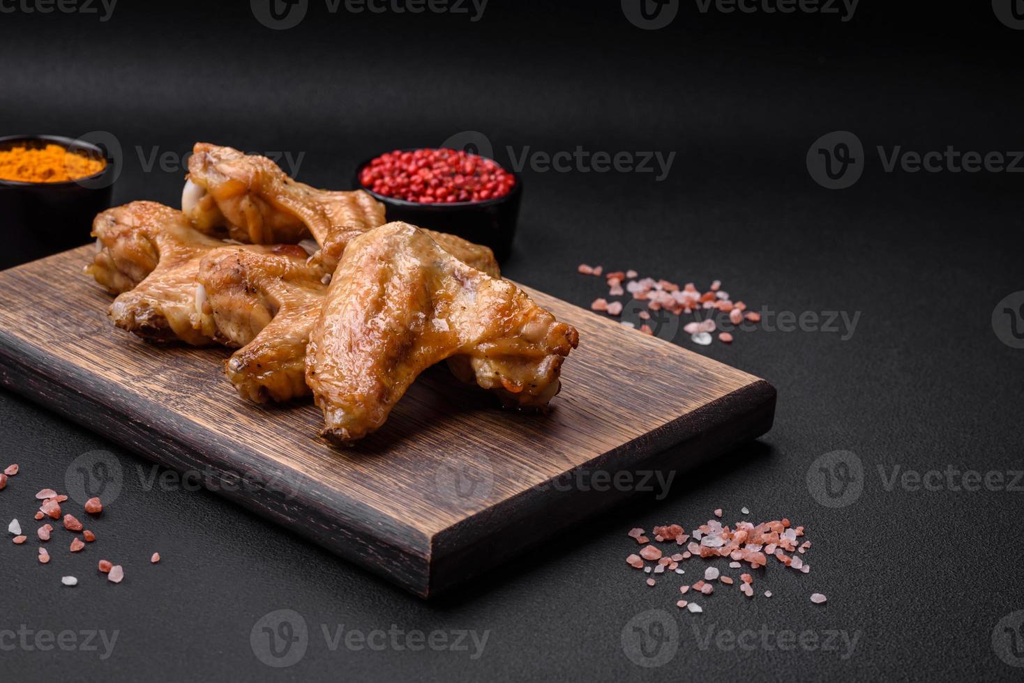 Baked chicken wings with salt, spices and herbs photo