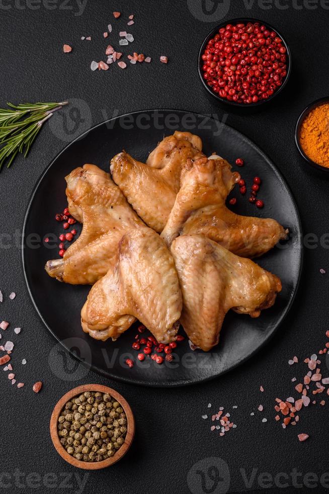 Baked chicken wings with salt, spices and herbs photo