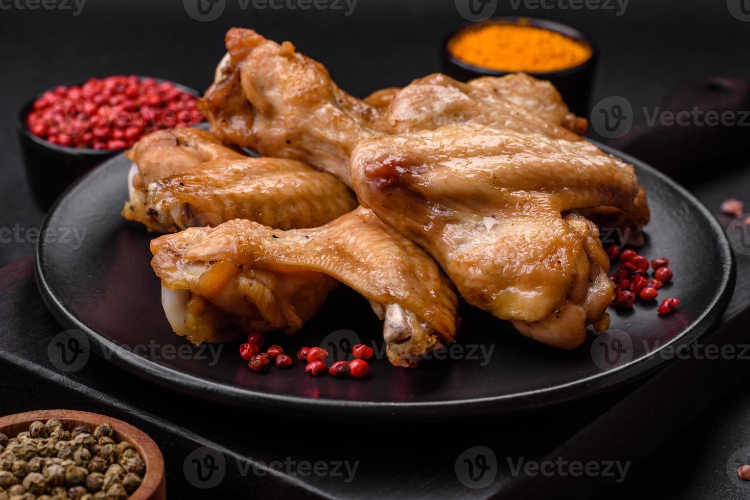 Baked chicken wings with salt, spices and herbs photo