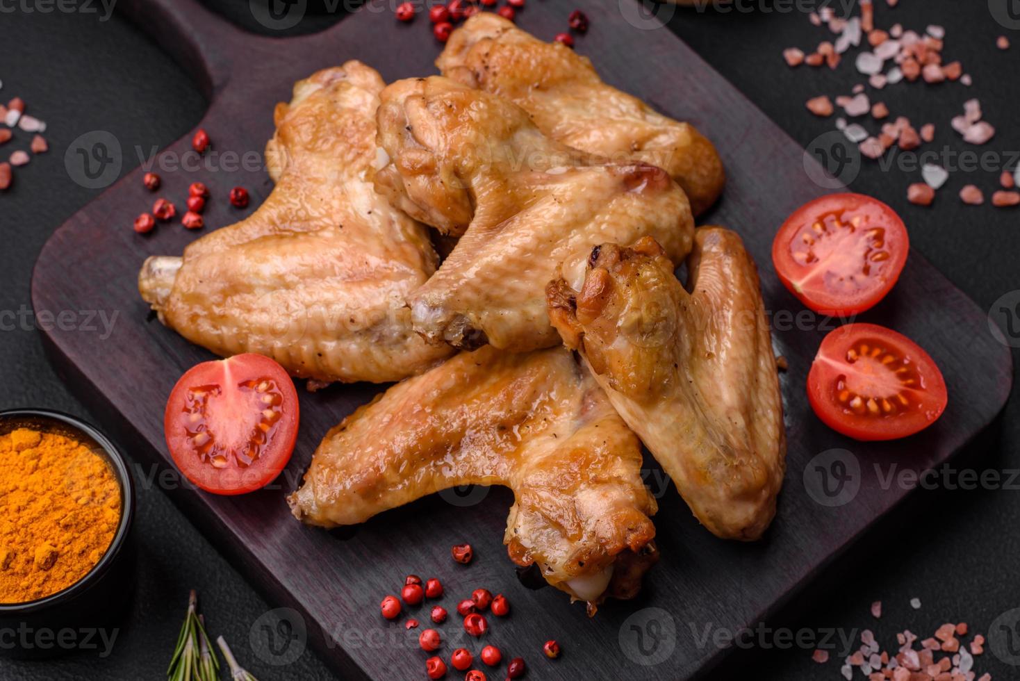 Baked chicken wings with salt, spices and herbs photo