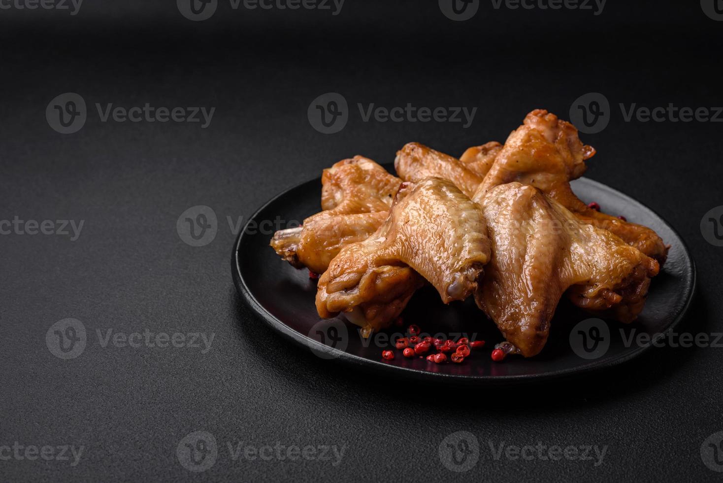 Baked chicken wings with salt, spices and herbs photo