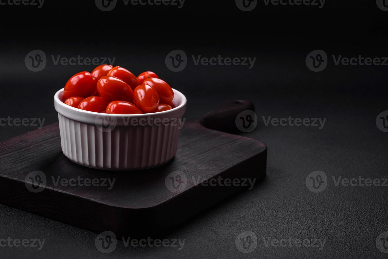 Fresh tasty cherry tomatoes in a white ribbed bowl photo