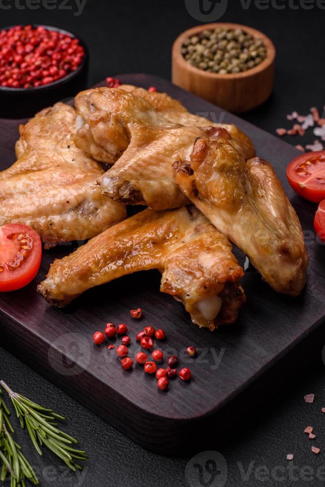 Baked chicken wings with salt, spices and herbs photo