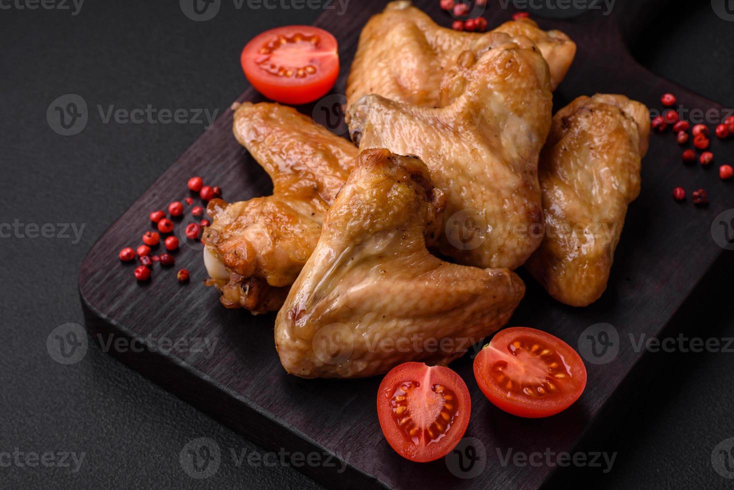 Baked chicken wings with salt, spices and herbs photo