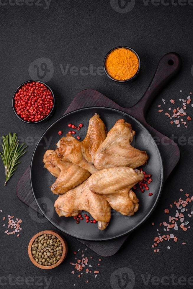 Baked chicken wings with salt, spices and herbs photo