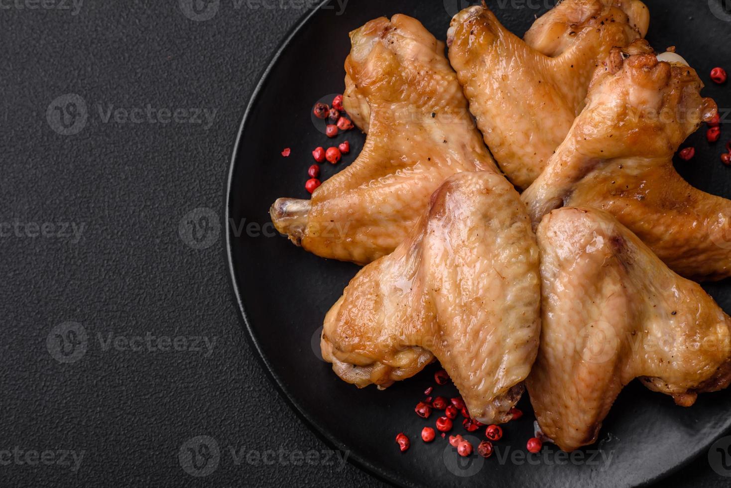 Baked chicken wings with salt, spices and herbs photo