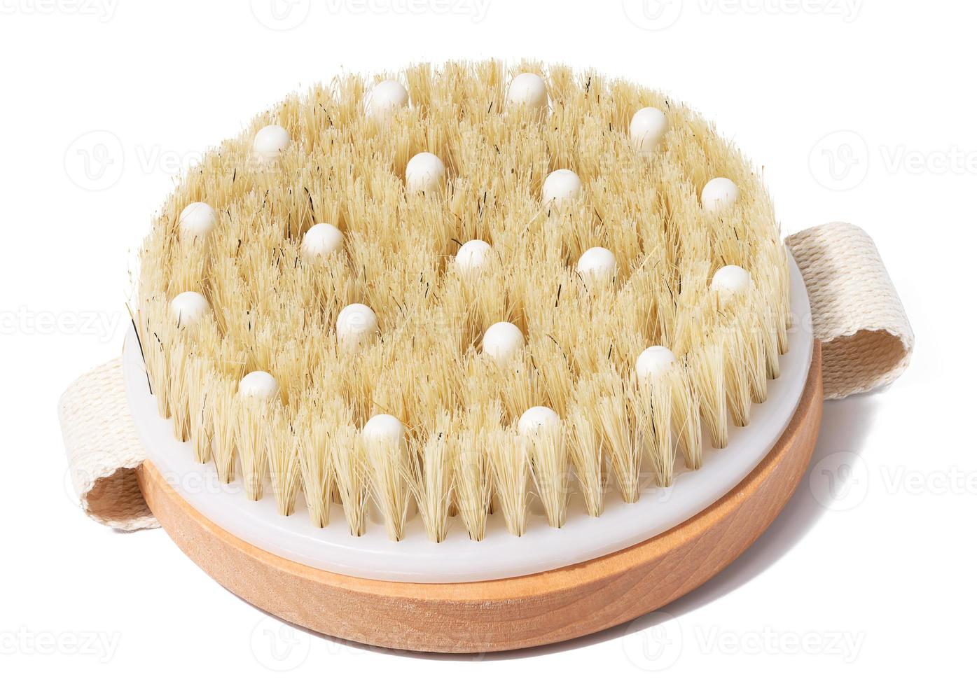 Wooden round body massage brush on white isolated background photo