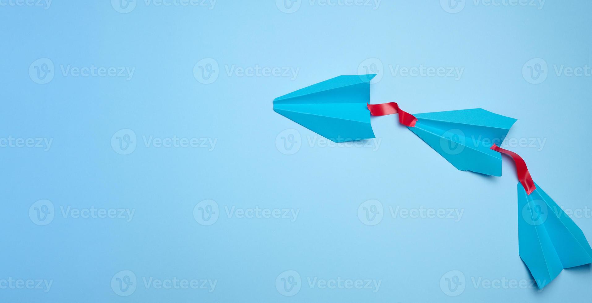 A group of blue airplanes follows each other, a concept of mass influence and manipulation photo