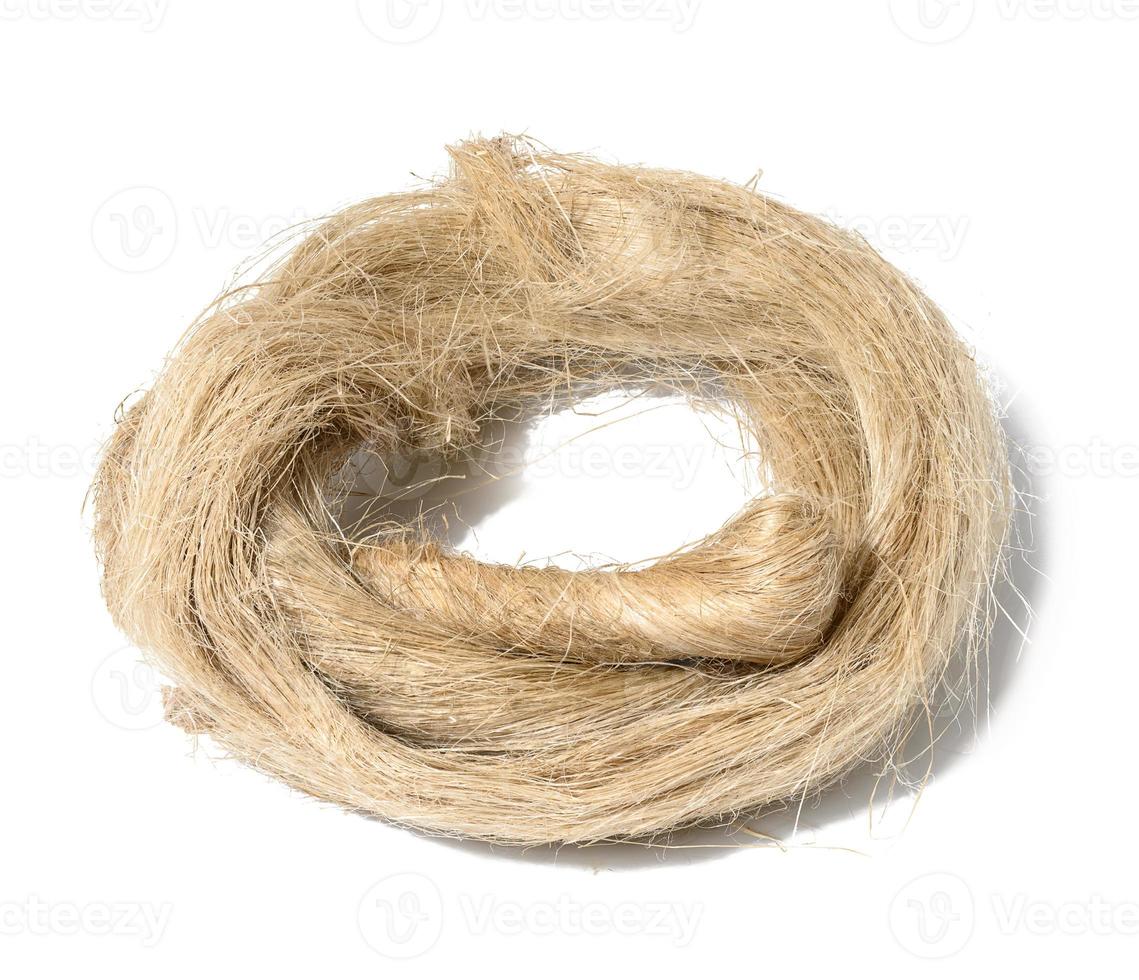 Coiled hemp rope on white background, fiber for plumbing work photo